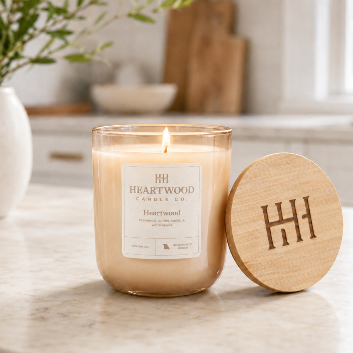 Refillable 10 oz hand-poured soy candle in a champagne-colored glass jar with wooden lid